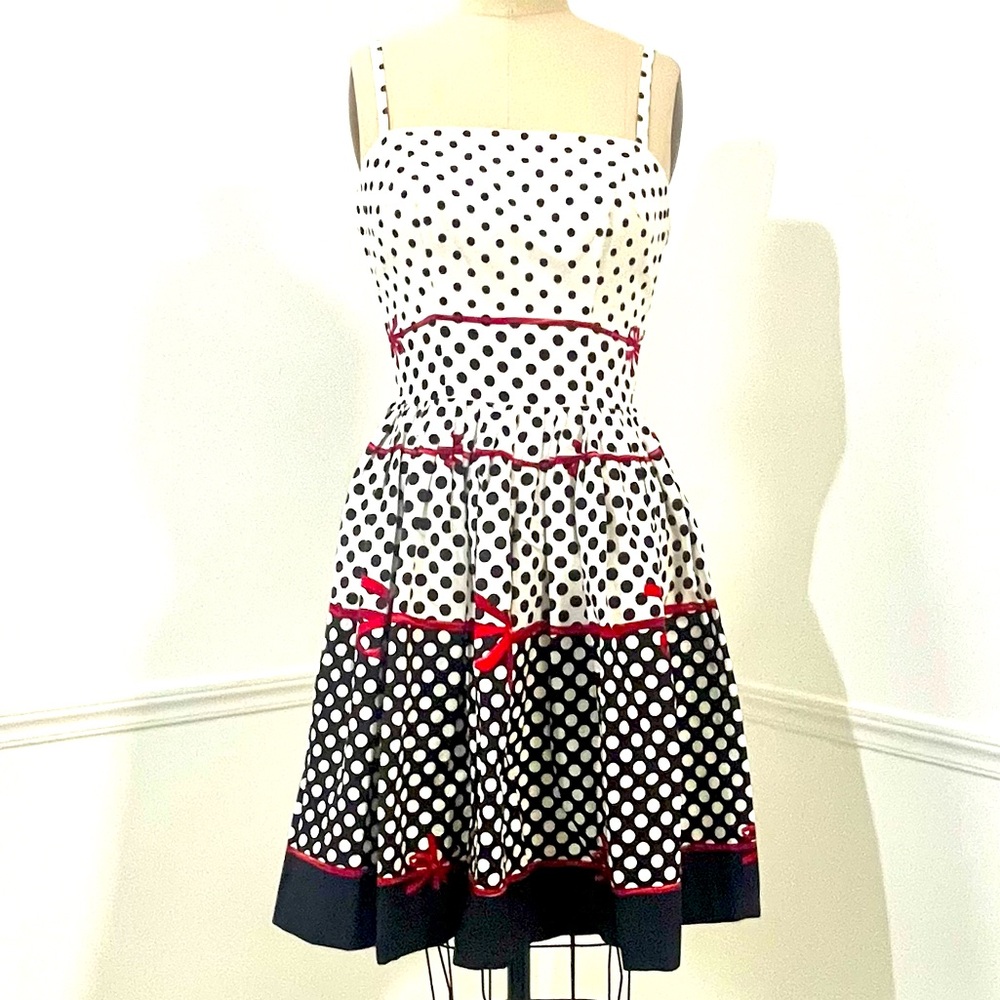 Vintage 1950s summer cocktail dress, black and white Polk dots and red bows.